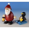Weihnachtsmann mit Schlitten und Pinguin